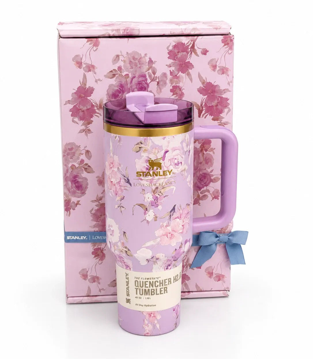 Floral-patterned Stanley tumbler with a matching pink box on a white background